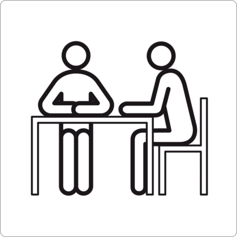 two talking people sitting at a table