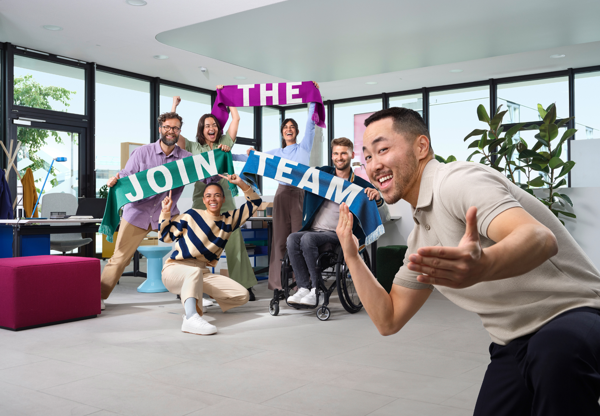 a group of people holding a colorful sign "Join the time"