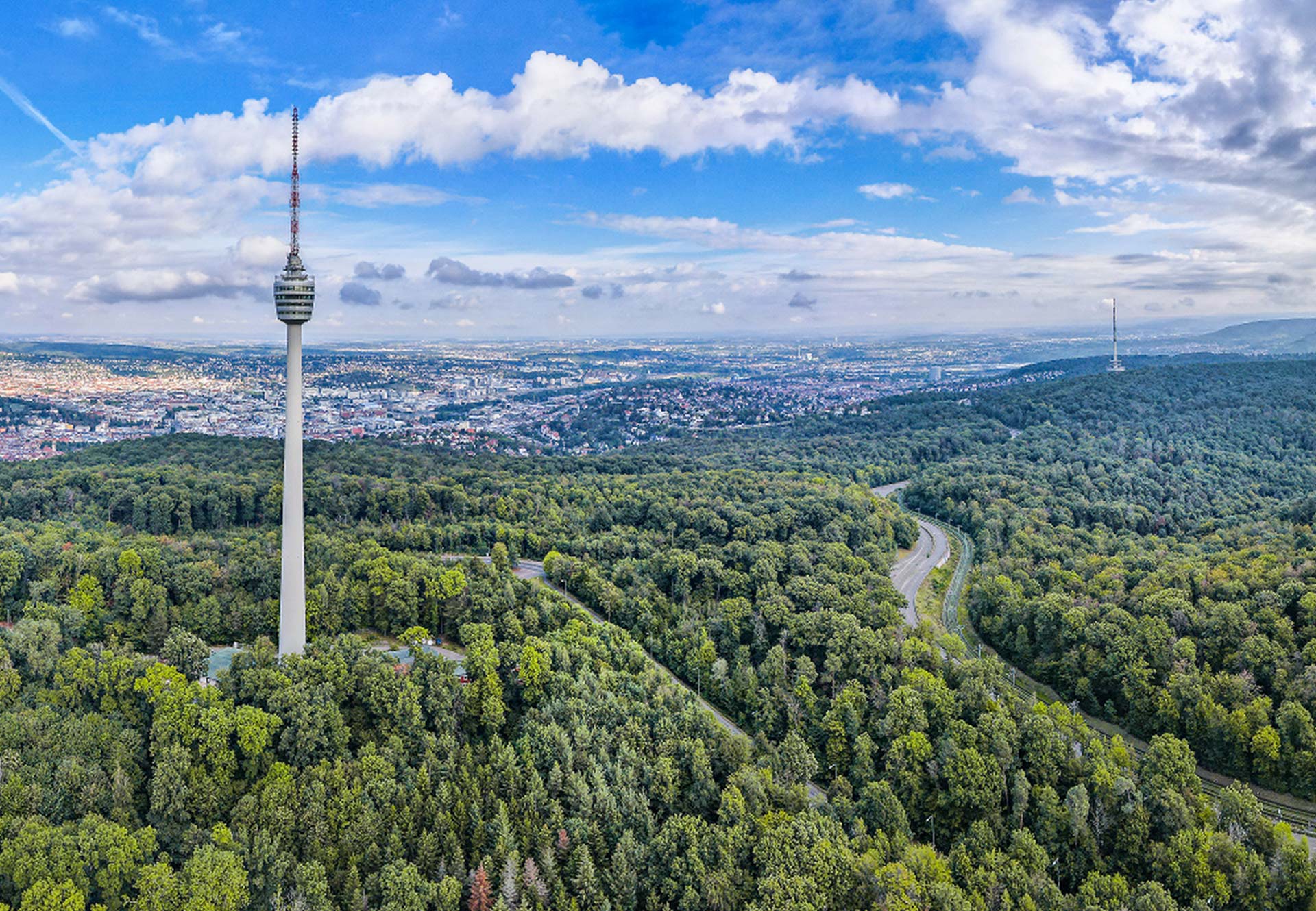 View of the Stuttgart Fernsehturm, which is surrounded by forest and nature.